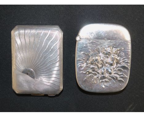 A rounded rectangular Vesta case, monogrammed and embossed with cherubs, stamped 'STERLING'; a silver Art Deco rectangular Ve