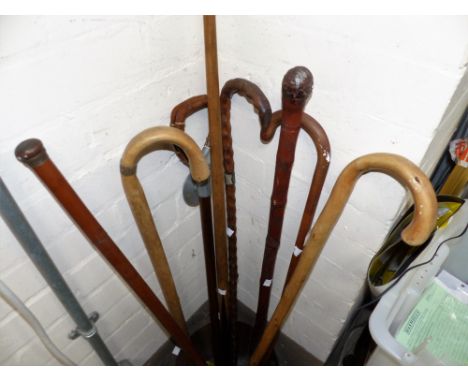An Edwardian walking cane with inset glass flask; other sticks