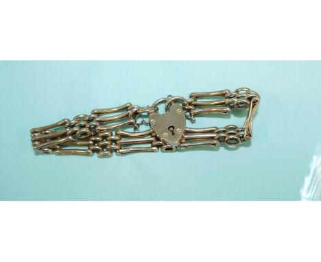 A rose gold gate bracelet stamped '9c with 9 carat heart lock and safety chain, 12.9gm
