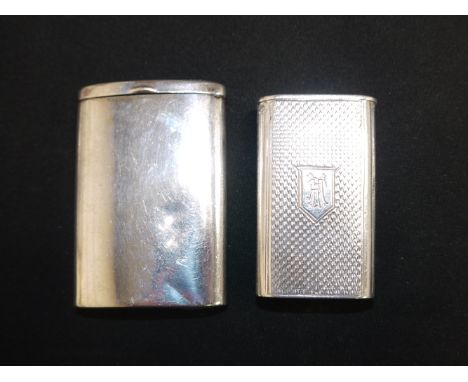 A silver rounded rectangular Vesta case with slide-out action, Birmingham 1925; an engine turned Vesta case, monogrammed, wit