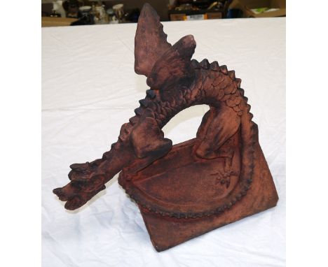 A terracotta ridge roof tile in the form of a dragon