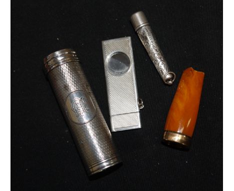 A silver cigar cutter, engine turned, Birmingham 1973; a silver shaving brush, engine turned, in tubular container, London 18