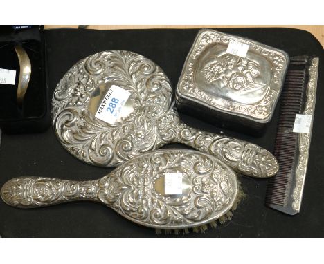 A silver embossed back hairbrush, hand mirror and comb, stamped 'STERLING'; a  leather trinket box with cherub embossed silve