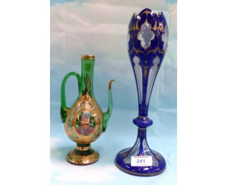 A 19th century blue and gilt overlaid cut back glass vase; an ornamental green and gilt glass water jug with enamelled portra