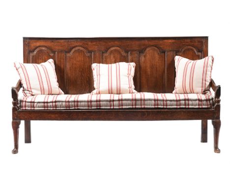 A GEORGE III OAK SETTLESECOND HALF 18TH CENTURY The panel back above solid seat108cm high, 186cm wide, 83cm deepCondition Rep