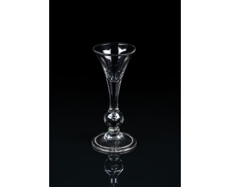 A BALUSTER GIN GLASSSECOND QUARTER 18TH CENTURYOf drawn trumpet baluster form with tear inclusion and a folded conical foot, 