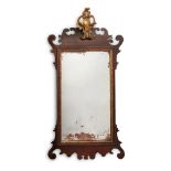 A MAHOGANY AND PARCEL GILT WALL MIRROR