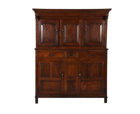 AN OAK DUODARNEARLY 18TH CENTURYThe upper section with panel doors above base with three drawers and further panel doors188cm