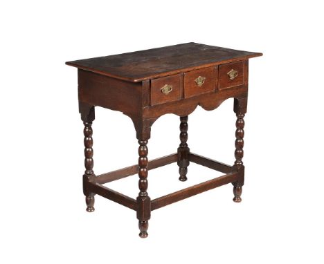 A QUEEN ANNE OAK SIDE TABLECIRCA 1700With arrangement of three drawers over bobbin turned legs76cm high, 84cm wide, 50cm deep
