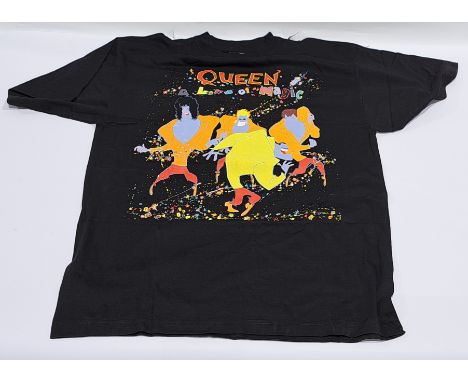 A collection of Queen related merchandise/memorabilia to include; "A Kind Of Magic" 1986 tour T-shirt, Queen 25 Years T-shirt