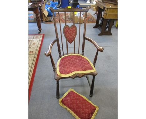 A 19th century country chair with part upholstered heart panel back and seat, open arms on turned legs united by elliptical s