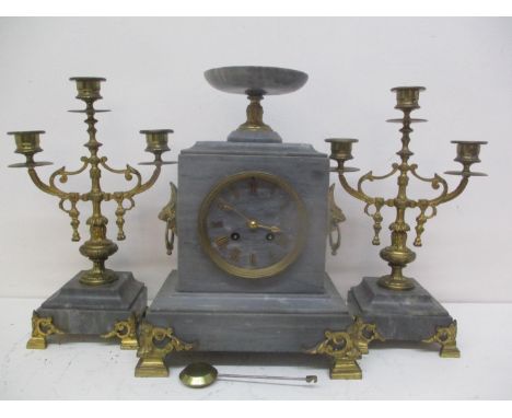 A 19th century French marble and gilt metal mantle clock with two matching garnitures.  The clock surmounted by a pedestal sh