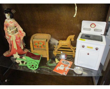 A vintage Amersham enamelled child's toy cooker and other vintage toys to include a dolls house metal vacuum cleaner 