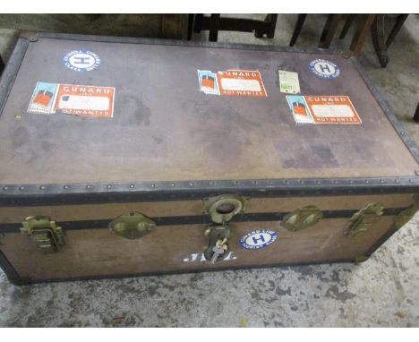 A vintage trunk with travelling stickers including Cunard A/F 