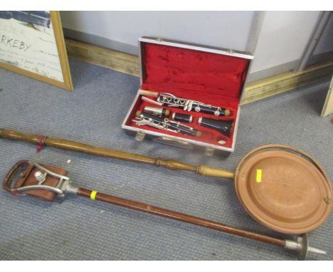 A Boosey &amp; Hawkes clarinet, together with a warming pan and a shooting stick 