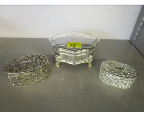 A silver plated trinket box with stamped Royal Coat of Arms to lid, on lion paw feet, velvet lined, and two other trinket box