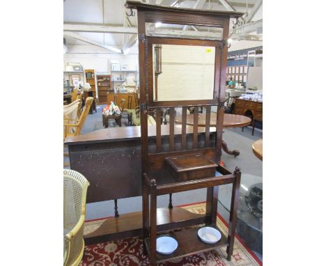 An early 20th century oak hall stand, reputedly from Wales, having two vintage enamelled bowls below 
