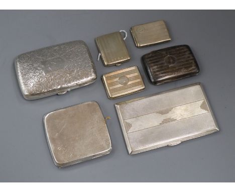 An engraved silver cigar case, three silver cigarette cases and three match cases, some engine-turned.