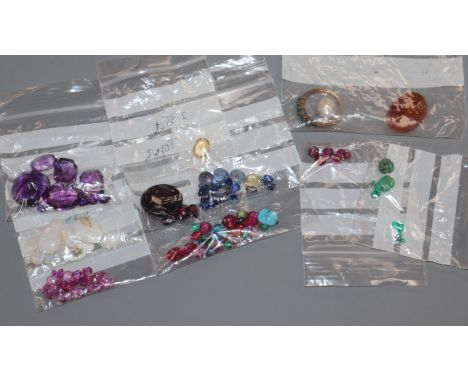 A collection of assorted unmounted gem stones, including white opal, amethyst, turquoise and citrine.