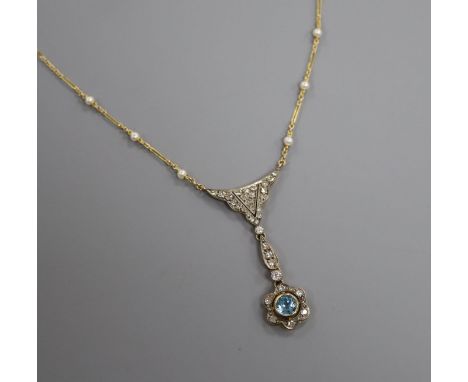 An Edwardian style yellow metal, blue topaz, diamond and seed pearl set drop pendant necklace, pendant 5cm.