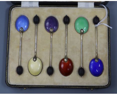 A cased set of six George V silver and polychrome enamel bean end coffee spoons.