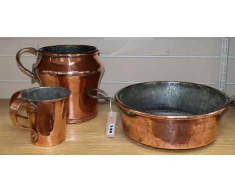 A copper preserve pan, a large copper jug, a double-handed jug and two tankards tallest 23cm