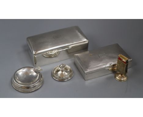 Two silver cigarette boxes, engine-turned and monogrammed and a silver matchbox stand and two ashtrays (weighted)