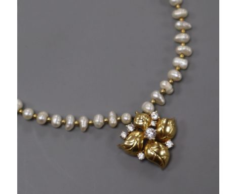 An 18k yellow metal and diamond set pendant, on a baroque cultured pearl and yellow metal spacer necklace, pendant 23mm.