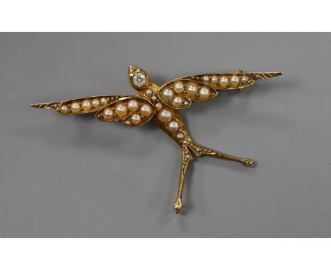 A Victorian 15ct, seed pearl and diamond set swallow brooch, 49mm.