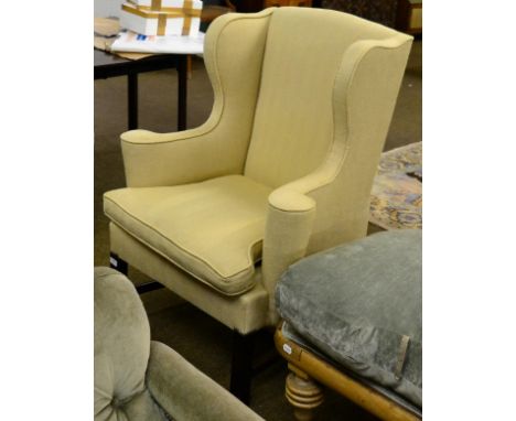 A Georgian style wingback armchair and another similar 