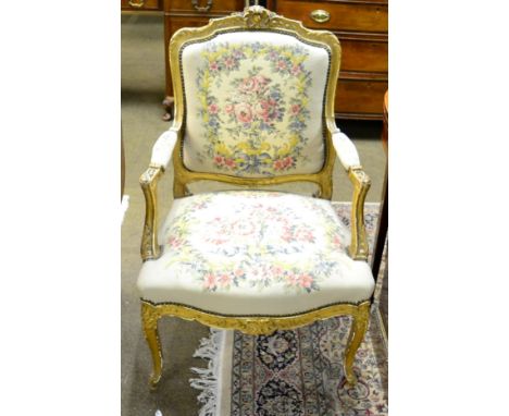 A Louis XV style gilt and gesso open armchair 