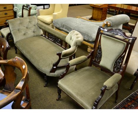 A late Victorian part salon suite comprising a sofa/chaise and a pair of open armchairs 