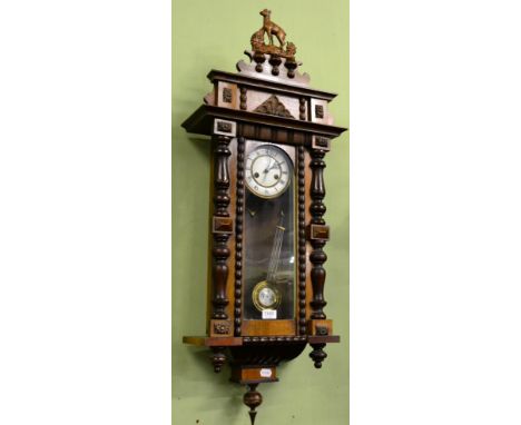 A regulated wall clock with decorative case 