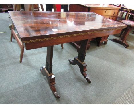 REGENCY CARD TABLE, A quality rosewood veneered swivel top card table with a cross banded top and gilded decoration on brass 