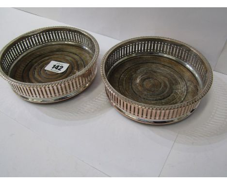 DECANTER COASTERS,&nbsp; A pair of plated decanter coasters with pierced borders and turned wood bases, 5.5" dia
