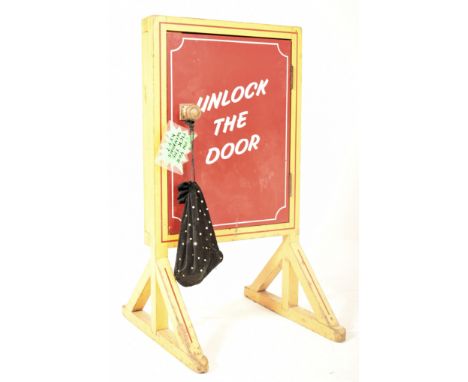 A vintage 20th century fairground / funfair / amusement park Unlock the Door game. The game with yellow painted wooden frame,
