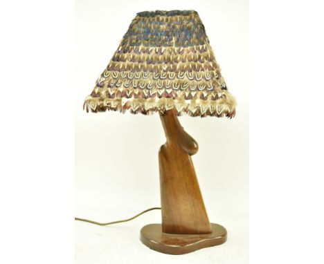 A vintage 20th century upcycled gun stock / butt gun desk / table lamp light. The lamp having a feather covered shade with th