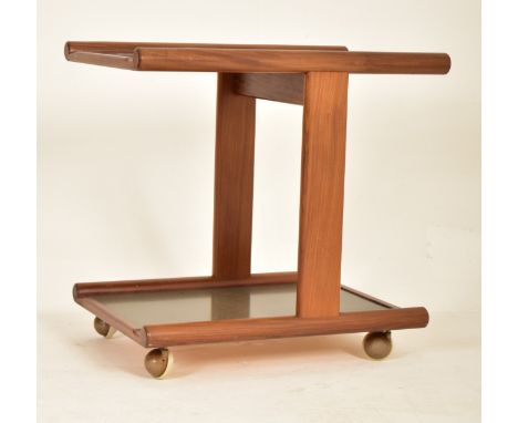 A retro mid 20th century Danish influenced teak two tier tea / cocktail drinks trolley. The trolley having two tiers with rou