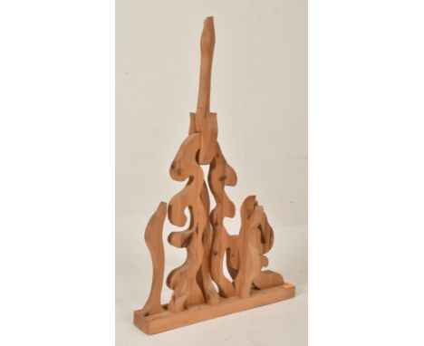 An unusual vintage 20th century wood-worked geometric abstract standing sculpture. The carved wooden sculpture of free form w
