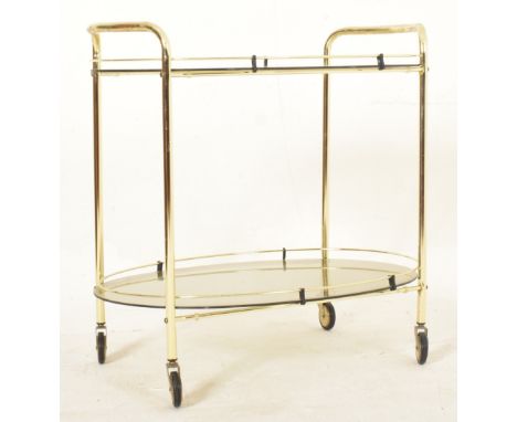 A vintage 20th century 1970s Italian style smoked glass drinks / cocktail trolley. The trolley of oval shape, featuring two t