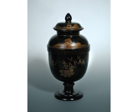 An early 19th century German chinoiserie lacquered wood ovoid urn and cover, the latter with acorn finial, the black ground o