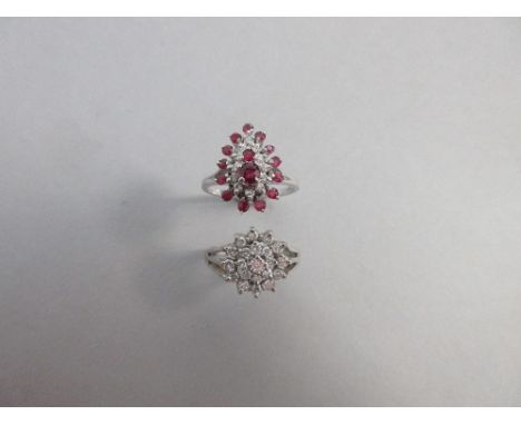 A ruby and diamond cluster ring set in 18ct white gold and a diamond flowerhead cluster ring, the first ring designed as a pe