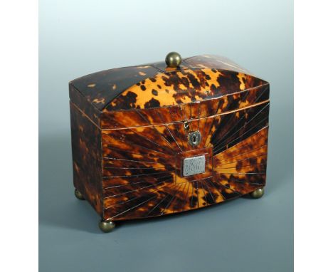 A George III tortoiseshell tea caddy, the brass ball topped rectangular hinged lid with bowed front and closing about two int