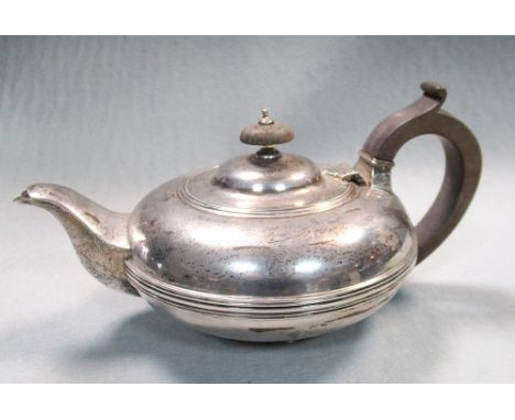 A George V silver circular teapot, by Fordham and Fordham, Sheffield 1927, of compressed circular form with applied reeded gi