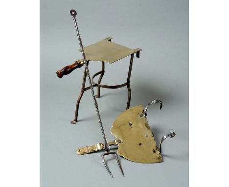An early 18th century brass gate-trivet,  a hearth trivet and an 18th century steel flesh fork (3)  