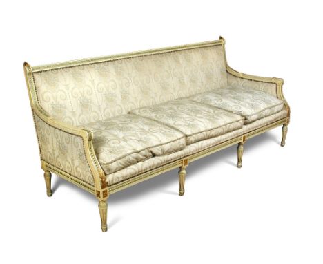 A Loius XVI style parcel gilt frame sofa, with leaf carved finials and leg capitals to a cream and green painted frame, squar