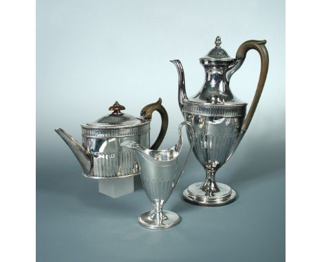 A George III silver three piece tea and coffee set, by John Wakelin & William Taylor, London 1786, the oval teapot half flute