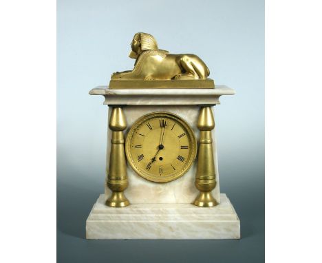 A Regency white marble mantle timepiece, surmounted by an ormolu model of the Sphinx, gilt dial flanked by gilt pilasters, ci