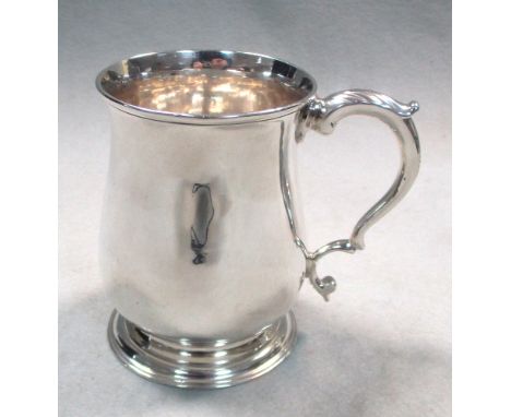 A George III silver half-pint tankard, possibly by John King, London 1769, of plain baluster form with leaf capped double scr