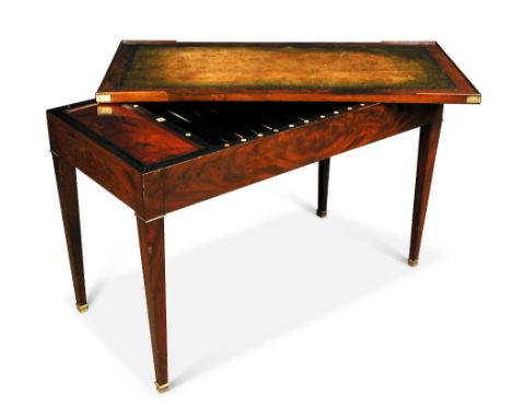 A French empire mahogany 'Tric Trac' table, with a removable leather lined top to reveal a fitted interior as a gaming table,